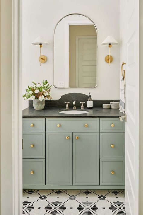 Guest bathroom design + guest bathroom remodel+ brass hardware + brass light fixtures + brass scones + polished nickel faucet + black countertop + colored vanity + tile design. untitled image Blog | Lexi Westergard Design - Phoenix Interior Designer | LWD | LW Home | Green Bathroom Vanity, Gold Framed Mirror, Arched Mirror, Custom Vanity, Custom Mirrors, Brass Mirror, Green Bathroom, Guest Bath, Guest Bathroom