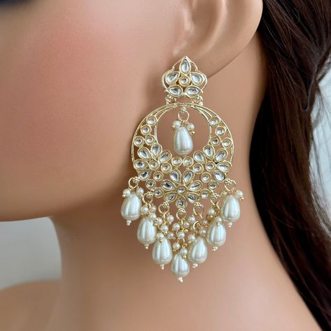 White gold Pearl Kundan chandbali Earrings, White chandbali earrings, Indian pakistani wedding jewelry, bridesmaid gift Indo Western Chand Earring With Gold Plating Height = 90 Mm || Width = 48 Mm Product Weight = 18 grams each earring  Long Earring Indo Western Earring Arrives in a gift box Color, shades, texture displayed may slightly vary from the actual product due to digital image limitations. We request you to consider these minor variations. Please expect the possibility of some slight im Chaand Baaliyan Earings, White Earrings Indian, Chandbali Earrings Kundan, Chand Bali Earrings Gold, Long Earrings Indian, Chandbali Earrings Gold, Pearl Earrings Indian, Pakistani Wedding Jewelry, Western Earring