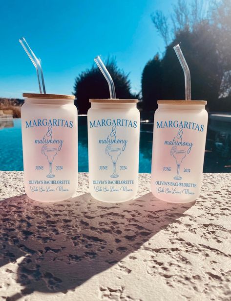 Bachelorette Party Tumblers  Margaritas and Matrimony  16oz Glass with bamboo lid and straw Printed in black ink unless otherwise specified ADD NAME TO BACK OF GLASS WITH BELOW LISTING: https://www.etsy.com/listing/1778007370/ HOW TO ORDER: 1. Enter cocktail design in order from left to right (choose 1-3 drinks) 2. Enter location of bachelorette party and date  3. Enter name of Bachelorette (Bride) 4. Enter color # from chart Margarita Bachelorette, Bach Party Favors, Bachelorette Party Lake, Bachelorette Party Unique, Bachelorette Party Drinks, Party Favors Bachelorette, Mexico Bachelorette, Bachelorette Cups, Charleston Bachelorette