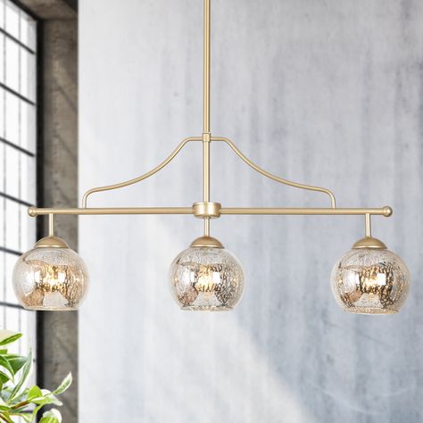 Bring a burst of light into your stylish modern home with this contemporary 3-light island chandelier. The light gold finish is bold and elegant to complement the surrounding features. Featuring contrasting classic clear glass shades and metal arms, this ZEVNI exclusive design offers a lofty, linear look ideal above bars, islands, and countertops. ZEVNI Mafia 3-Light Gold Transitional Chandelier | L3E3UQ73W4698ST7 Black Dining Room Light Fixture, Modern Black Dining Room, Modern Gold Kitchen, Kitchen Island Chandelier Lighting, Burst Of Light, Dining Room Light Fixture, Transitional Chandelier, Island Chandelier, Kitchen Island Chandelier