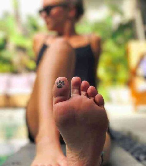 40 Best Hidden Tattoo Ideas | YourTango Tatoo Dog, Toe Tattoos, Pawprint Tattoo, Hidden Tattoos, Hamsa Tattoo, Paw Tattoo, Mother Tattoos, Geniale Tattoos, Disney Tattoo