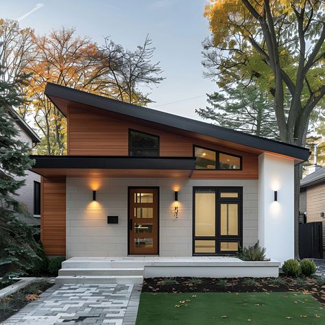 This stylish Scandinavian bungalow features a striking sloped roof and a blend of white stucco and wood siding. Large windows and a sleek door, flanked by minimalist wall lights, enhance the modern facade. The front yard boasts a paved walkway and a lush lawn, complementing the clean lines and natural materials. This design beautifully merges traditional Scandinavian elements with contemporary architecture, making it a perfect blend of elegance and modernity. Modern House Addition, White And Wood Modern House, Stucco Two Story House, Country Home Designs Exterior, Houses Exterior Simple, Minimalist Architecture House, White House Natural Wood Trim Exterior, Modern House Exterior Materials, Skillion Roof Facade Modern Exterior