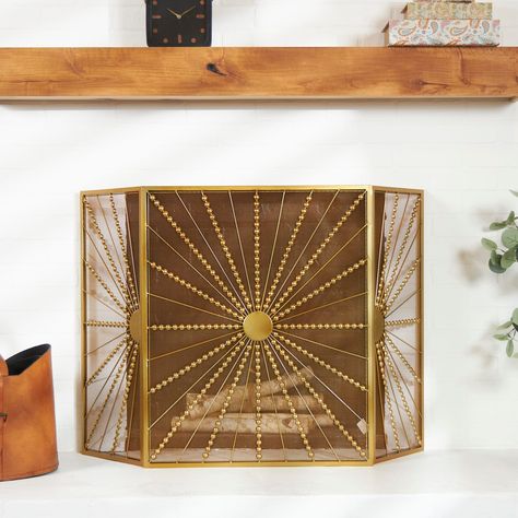 "Buy the The Novogratz Gold Metal Foldable 3-Panel Starburst Fireplace Screen with Bead Inspired Rays at Michaels. com. This protective fireplace spark screen features a sturdy and foldable metal construction for long-term use and easy storage. Indulge in the glamorous luxury of plush textures, dazzling details, and sleek finishes to elevate your home and add a sophisticated flair. This protective fireplace spark screen features a sturdy and foldable metal construction for long-term use and easy Cat Proof Fireplace, Candle Cluster, Metal Fireplace, Gold Dinnerware, Starburst Design, Fireplace Screen, Fireplace Screens, House Things, Mesh Screen