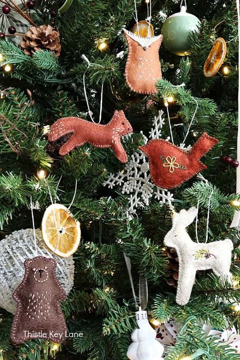 Simple Felt Woodland Animal Christmas Ornaments - See how to create felt ornaments for your Christmas tree or for handmade gift toppers. Simple Felt Patterns and Embroidery Ornaments. Woodland Theme Ornaments Or Decorations. Woodland Felt Animals Fox, Bear, Owl, Deer, Bird. Woodland Theme Tree Topper, Christmas Tree Animal Theme, Felt Animals Christmas, Christmas Decorations Knitted, Nordic Felt Christmas Decorations, Animal Christmas Decorations, Woodland Animal Christmas Ornaments, Christmas Tree With Felt Ornaments, Woodland Creatures Christmas Tree