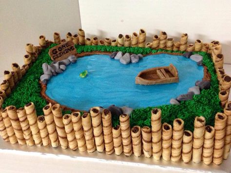 Fishing pond cake with pretty blue water. Going to add beavers to this and take away the boat per son's request.  Think I'll nail it?  LOL Torturi Baby Shower, Pond Cake, Fish Cake Birthday, Fishing Pond, Fishing Birthday Party, Fishing Party, Fishing Birthday, Fish Cake, Cakes For Men