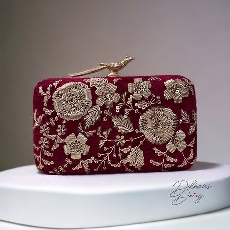 Introducing our Box Clutch with Hand-Embroidered Zardozi Work--a perfect blend of opulence and craftsmanship. Immerse yourself in the luxury of premium quality as we present a meticulously designed accessory that stands out from the rest. Crafted with a premium quality frame and adorned with hand-embroidered Zardozi work, this clutch is a testament to the artistry and attention to detail that sets it apart. The lavish velvet material adds a touch of sophistication, ensuring you carry an accessor Luxury Handmade Traditional Clutch, Luxury Zari Work Wedding Clutch, Maroon Clutch, Zardozi Work, Velvet Clutch, Handmade Clutch, Party Clutch, Wedding Clutch, Bridal Clutch