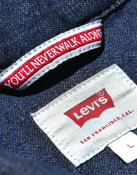 Football clubs have all sorts of official partners these days. ‘Health Insurance’, ‘Skincare’ and ‘Gaming’ Providers are all genuine partners with Premier League teams. But there’s probably no more random official partner than Liverpool FC’s official ‘Denim Partner’. That said, it is Levi’s. And the first ever Levi’s x LFC capsule collection does provide some standout pieces. Hang Tags Clothing, Denim Label, Premier League Teams, Packaging Company, Shirt Label, Levis Shirt, Estilo Denim, Best Mens Fashion, Fabric Labels