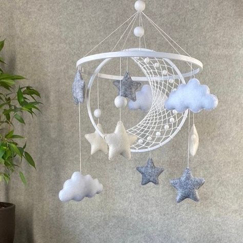 Baby mobile neutral with dreamcatcher macrame moon and stars will enhance your nursery. Gift Baby shower decor arm hanger holder wood oak. This baby crib mobile is a whimsical addition that not only adds charm to your nursery but also makes a fantastic baby shower or expecting mom gift. 💕The size: Circle radius 9,4-9,8 ( 22-24 cm) Total length is approximately 15 inches (40cm) including the smaller part the hanger. The mobile can be made in any color combination. Write what colors you are interested in, attach photos of your nursery or just the pictures you like, and I will select color options for you and together we will create the mobile of your dreams! 💕Materials: 🌟felt,  🌟beech ring, 🌟Durablenylon cord. 💕Shipping: FREE SHIPPING for all mobiles. Note: The color may vary slightly Baby Mobile Ideas, Oak Nursery, Macrame Baby Mobile, Moon And Stars Nursery, Dreamcatcher Macrame, Macrame Dreamcatcher, Stars Baby Mobile, Macrame Baby, Hanger Holder