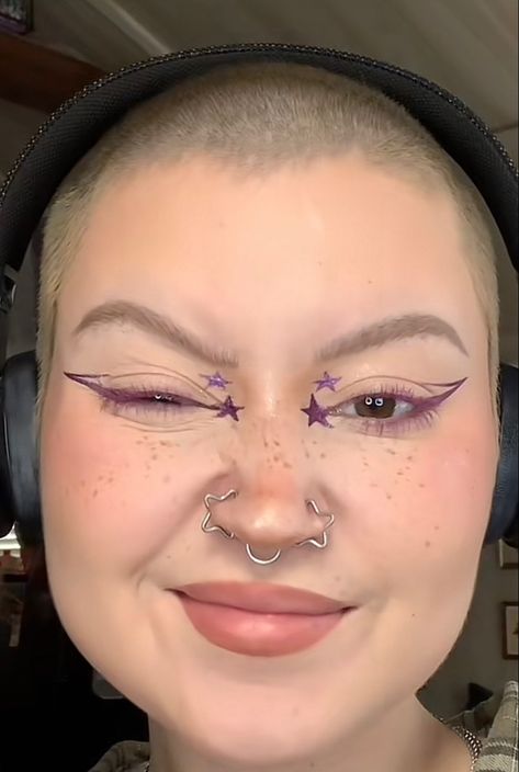 Star Shaped Nose Ring, Graphic Purple Eyeliner, Star Shaped Eyeliner, Star Makeup Inner Corner, Star Nose Rings, Star Graphic Liner Makeup, Graphic Liner Purple, Symmetrical Nose Piercing, Rock Star Eye Makeup