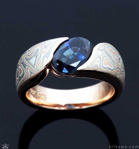 Mokume Wave Engagement Ring with an oval sapphire solitaire! Pictured here in 14k rose gold and our Champagne Mokume. Customize this design by choosing your favorite metal, mokume and solitaire stone! Oval Stone Ring Design Gold Men, Mens Ring Designs, Vintage Gold Engagement Rings, Earrings Ideas, Mens Gold Jewelry, Sapphire Solitaire, Modern Engagement Rings, Aquamarine Engagement Ring, Engagement Ring White Gold