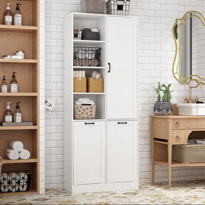 Maximize your bathroom storage with our elegantly designed bathroom linen cabinet. This cabinet offers a perfect blend of functionality and style, featuring a clean white finish that complements any bathroom decor. With four open shelves, a single-door cabinet with adjustable shelves, and two bottom tilt-out laundry hamper cabinets, this versatile piece provides ample space for all your bathroom essentials. The black metal handles and reinforced base add a touch of sophistication and stability, Laundry Hamper Cabinet, Tilt Out Laundry Hamper, Dirty Clothes Basket, Bathroom Linen Cabinet, Laundry Baskets, Linen Cabinet, Clothes Basket, Door Cabinet, Open Shelves