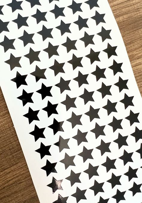 1/2 Inch (13 mm) Mini Star Sticker Sheet **Colors shown in listing photo are GLOSS BLACK, HOLO OPAL WHITE, and PINK **78 stars per sheet** These mini stickers are made of permanent grade adhesive vinyl and are water and weather resistant. These stickers can be used on various smooth surfaces such as paper, metal, glass, laptops, iPads, cell phones, tumblers, etc. Vinyl stickers are easily removed, but are not reusable. Seller is not responsible for stickers during application. Holo Stickers, Grunge Tattoo, Mini Stickers, Tiny Star, Opal White, Star Stickers, Aesthetic Stickers, Sticker Sheet, Gloss Black