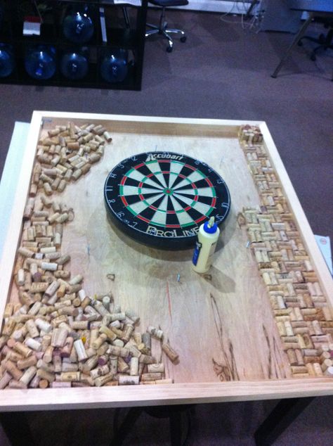 Custom dart board frame with wine cork backing, located in our design studio for brainstorming meetings at www.sixhalfdozen.com Framing A Basement, Custom Dart Board, Dart Board Wall, Best Darts, Dart Shirts, Cork Projects, Home Bar Accessories, Man Cave Basement, Cork Art