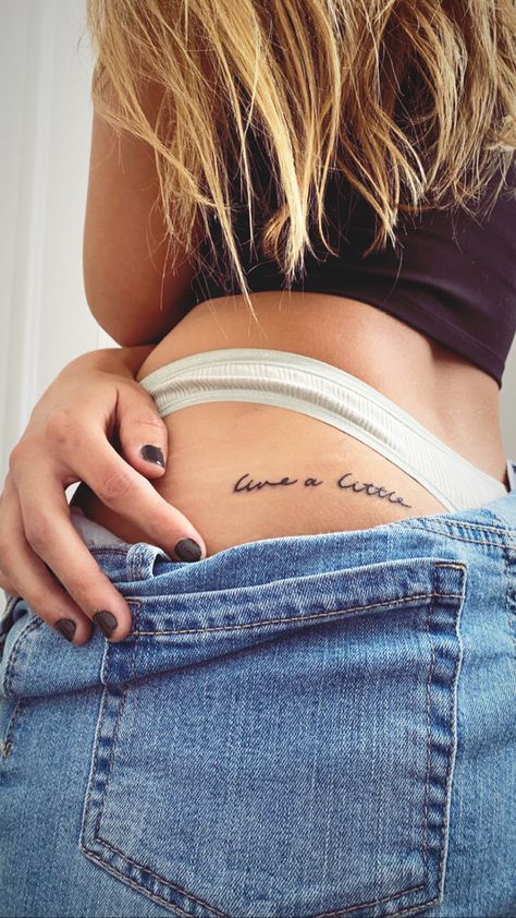 “Live a little” Pelvic Tattoo Hip Small Words, Top Of Buttcheek Tattoo, Side Hip Tattoos Women Quotes, Hip Tattoos Women Words, Hip Tattoos Women Small Quotes, Side Of Hip Tattoo, Live A Little Tattoo, Yes Sir Tattoo, Hip Tattoos Women Small