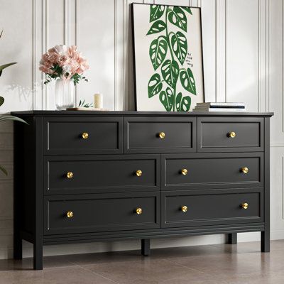 Introducing our exquisite dresser, a perfect blend of style and practicality for your bedroom haven. Crafted with precision from high-quality materials, this dresser boasts 7 spacious drawers adorned with gleaming gold knobs, infusing a touch of opulence into your living space. Its elegant seamlessly integrates into any interior design scheme, from classic to contemporary, exuding timeless charm. Sitting atop sturdy legs, the dresser ensures stability while maintaining an air of refined grace. E Long Black Dresser Bedroom, Black Gold Dresser, Black Dresser With Gold Hardware, Black And Gold Dresser, Dresser With Gold Handles, Black Dresser Bedroom, Dresser Modern, Dresser Black, Bedroom Things