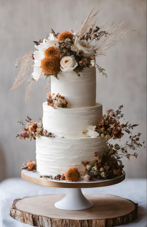 White tiered wedding cake with dried flowers Boho Wedding Cake Florals, White Boho Wedding Cake, Elegant Boho Wedding Cake, Terracotta Cake Wedding, Rustic Orange Wedding Cake, Carrot Wedding Cake Rustic, Real Flower Wedding Cake, Cookies And Cream Wedding Cake, Fall Flowers Cake