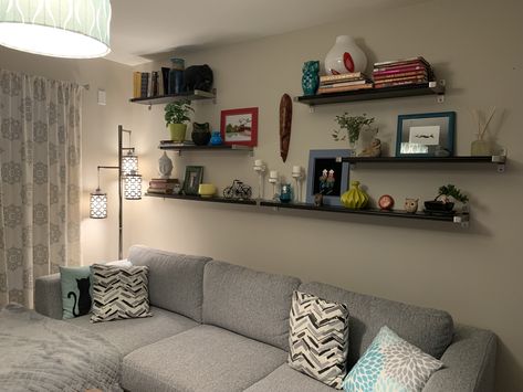 Floating Shelves Living Room Long Wall, Industrial Shelves Above Couch, 4 Shelves On Wall Arrangement, Floating Shelves Living Room Behind Couch, Living Room Picture Ledge Over Couch, Book Shelf Above Couch, Living Room Wall Shelves Above Couch, Floating Shelves Behind Sofa, Long Wall Shelf Living Room