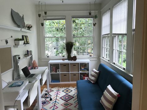 Home office sunroom Moroccan rug shelves white futon teal workspace Futon Home Office, Small Office With Futon Ideas, Tiny Sunroom Office, Home Office With Futon Ideas, Futon In Office Ideas, Home Office Futon, Small Office With Futon, Sunroom Guest Room Combo, Small Sunroom Office