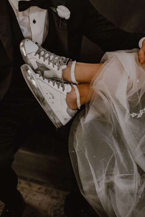 A bride's shoes are on her groom's lap. She wears Golden Goose sneakers with silver accents. Golden Goose Wedding Sneakers, Golden Goose With Wedding Dress, Bridal Golden Goose, Bride Golden Goose, Wedding Day Sneakers, Golden Goose Wedding Shoes, Golden Goose Sneakers Aesthetic, Golden Goose Wedding, Wedding Golden Goose