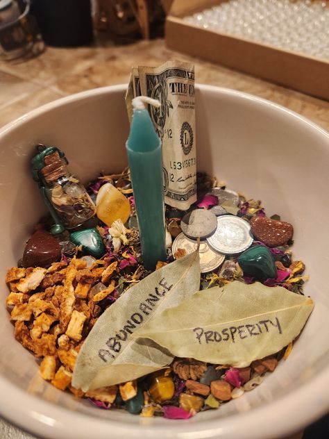 With simple ingredients and an easy set up, this Money Bowl Kit is the perfect addition to your altar or living space. *Please note: this kit does not come with the bowl or coins/dollar bills. Store bought dried bay leaves work best to write your intentions onto when you need to change out the included bay leaves (Prosperity, Abundance, Bills Paid, Larger Paychecks, Free Gifts...etc) and a gold or green bowl works best, but it doesn't matter the size. Fit it to your available space.* **Place the rice at the bottom of the bowl, slide the green candle in, then sprinkle the herb mixture and gemstones around it, placing the Goldstone, Malachite & orange peel pieces wherever feels right to you. BEFORE USE: recite the included prosperity spell, and light the candle. Blow it out and relight it as Witchcraft Money Bowl, Money Bowl Ingredients, Money Bowls, Money Bowl Spell, Protection Oils, Money Altar, Money Magick, Money Bowl, Bills Paid