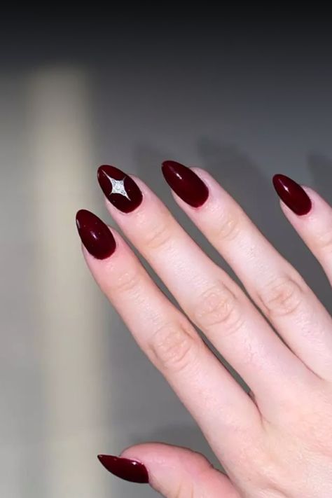 Achieve an elegant look with this glamorous dark red almond manicure. The deep red hue adds a touch of sophistication to your nails, perfect for any occasion. The unique almond shape creates a sleek and modern finish, making this manicure a standout choice for those who love luxurious style. Treat yourself to bold and beautiful nails with this stunning dark red almond manicure today! Nail Art Maroon Simple, Nail Art Maroon, Almond Manicure, Maroon Nail Art, Red Almond, Maroon Nails, Classic Nails, Almond Shape, Popular Nails