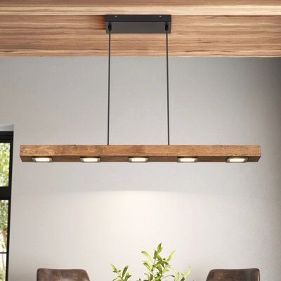 This 6-light linear pendant combines modern and rustic elements to create a striking focal point anywhere in your home. A large rectangular solid wood block hovers over your kitchen island or dining table, with LED bulbs integrated into it - four panels underneath and two above. It hangs with the help of two height-adjustable wires, and the black-finished iron canopy is compatible with sloped ceilings for your convenience. This luminary also works with dimmer switches, so you can easily control Kitchen Island Modern, Wood Lighting, Dining Room Light Fixture, Lamps For Kitchen, Slanted Ceiling, Minimalist Dining Room, Linear Pendant Light, Wood Roof, Kitchen Island Linear Pendant