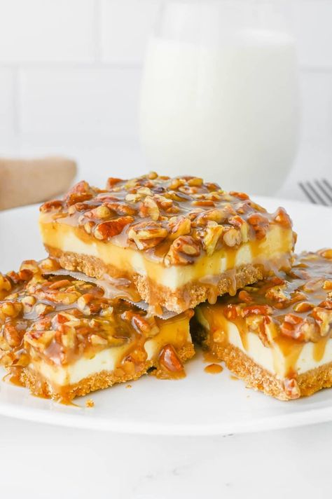 This delicious pecan pie cheesecake bar recipe is a wonderful fall dessert that falls under the category of, if you can't pick just one, have them both! That's right, we can have our cake and eat it too. With pie! No Bake Pecan Cheesecake Bars, Thanksgiving Pecan Desserts, Potluck Desserts Fall, Easy Fall Potluck Recipes, Pecan Pie Cheesecake Bars Recipe, Pecan Cheesecake Pie, Friendsgiving Dessert, Pecan Pie Cheesecake Bars, Pecan Cheesecake Bars