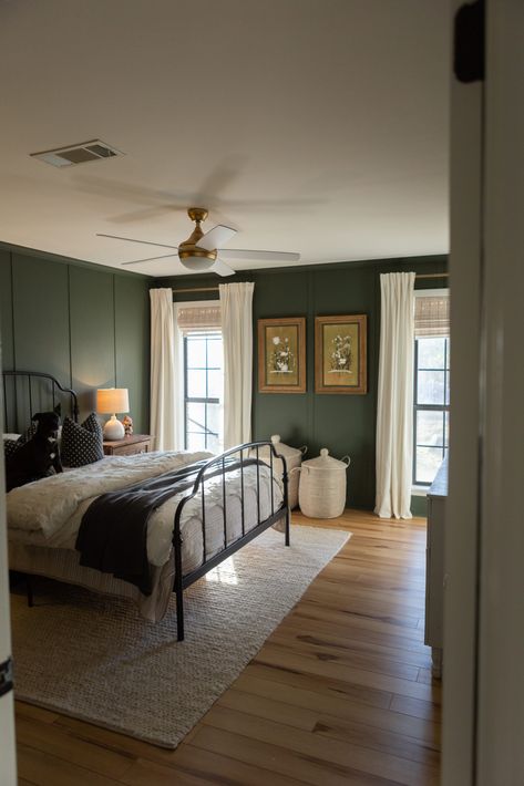 Dark green master bedroom with board and batten. House Design Moody, Light Bedroom Dark Accents, Edgy Green Bedroom, Front Entry Paint Colors Inside, Dark Green Walls Bedroom Decor, Dark Decor Bedroom Ideas, Chair Rail Bedroom Two Tones, Different Board And Batten Styles, Shades Of Green For Bedroom