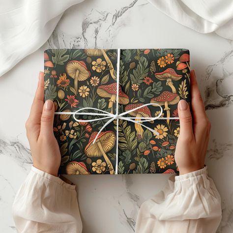 Bring a touch of nature to your gifts with our Mushroom Wrapping Paper! This enchanting forest-inspired gift wrap features whimsical mushrooms and botanical elements, perfect for those who love the cottagecore aesthetic. With its earthy, autumn tones, this moody wrapping paper adds a cozy and magical feel to any present. Whether for birthdays, holidays, or special occasions, this unique design is ideal for nature lovers and anyone looking to add a bit of woodland charm to their gift-giving. The Fairy Wrapping Paper, Whimsical Mushrooms, Cottagecore Christmas, Forest Gift, Mushroom Forest, Holiday Wrapping, Christmas Wrapping, Paper Gifts, Gift Baskets