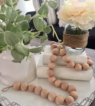 Wood Bead Garland - A decor trend we love | kikiinteriors.com Farmhouse Decor Trends, Wood Garland, Recycled Glass Vases, Living Room Design Inspiration, Bead Garland, Wood Bead Garland, Garland Decor, Affordable Home Decor, Pottery Pieces