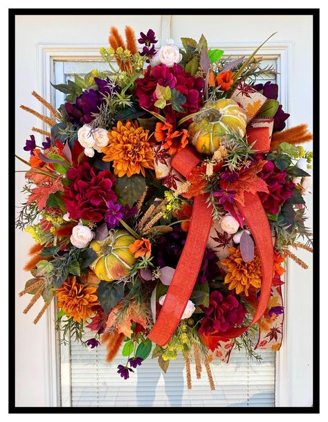 Colorful Autumn Door Wreath, Designer Fall Floral Wreath SUGAR CREEK DECORATINGVISIT MY SHOP AT LINK BELOW https://www.etsy.com/shop/SugarCreekDecorating?ref=ss_profile&section_id=21043858 This is a gorgeous colorful fall door wreath that is perfect for the harvest season all the way through Thanksgiving. It has gorgeous deep purple peonies, maroon hydrangeas, gold dahlias, cream mini ranunculus, orange cosmos and purple mini cosmos and a lot of other beautiful fall foliage and fillers and grasses, a lovely double bow and two pretty little pumpkins nestled within. It measures @ 28"L x 24"W x 8"D and is made on a 14" grapevine wreath. Great for the fall autumn season. All of my floral arrangements are unique and one of a kind with much attention to detail. For 20 years my love for flowers a Fall Hydrangea, Purple Peonies, Fall Thanksgiving Wreaths, Peonies Wreath, Door Wreaths Fall, Fall Door, Thanksgiving Wreaths, Dahlia Flower, Fall Decor Diy