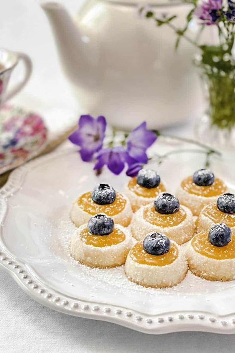 Shortbread Tea Cookies with Lemon Curd, crowned with fresh blueberries, are tiny bites of perfection. Petit and perfectly sized for afternoon tea, they are melt-in-your-mouth delicious. Afternoon Tea Cookies, Cookies With Lemon Curd, Cookies With Lemon, Tea Party Desserts, Tiny Bites, Baked Apple Dessert, Afternoon Tea Recipes, Lemon Curd Recipe, Apple Dessert