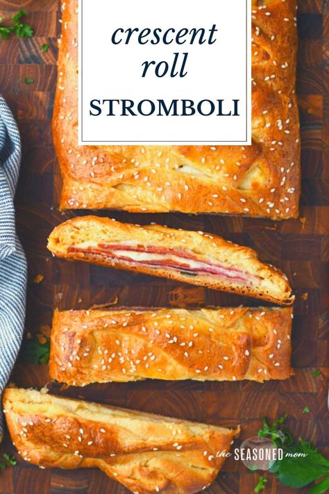 This easy crescent roll stromboli has all of the Italian meats and cheeses that you love in a classic stromboli recipe! Store-bought crescent roll dough is brushed with garlic butter, stuffed with ham, pepperoni, salami, Provolone, and mozzarella, and then baked in the oven until it's puffy, flaky, and golden brown. Serve the homemade stromboli sandwich with a side of marinara for a quick dinner, a fun party appetizer, or a simple gameday snack! Crescent Roll Stromboli, Stromboli Sandwich, Crescent Dough Sheet Recipes, Sheet Recipes, Crescent Braid, Cheese Stromboli, Easy Stromboli, Stromboli Recipe Easy, Crescent Roll Recipes Dinner