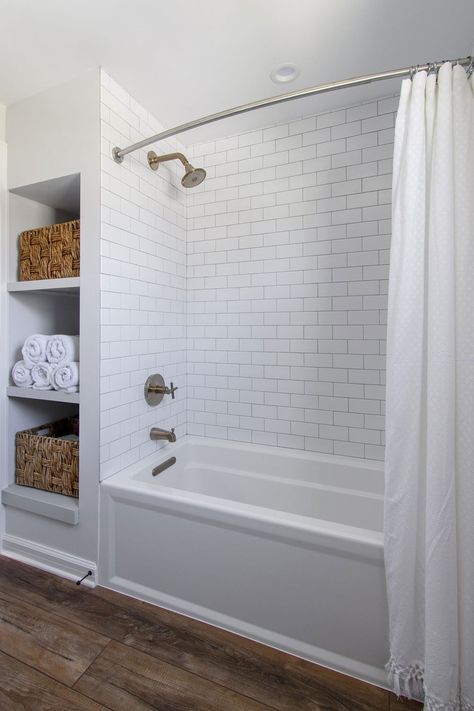 Subway Tile Bathroom Wood Floor, Tiled Bathroom Floors And Showers, Bathtub With Subway Tile, Hallway Bathroom With Tub, White And Wood Bathroom Small, Bathtub Subway Tile Surround, Subway Tile Shower With Tub, Subway Tile Shower Bath Combo, Tub With Herringbone Tile Walls