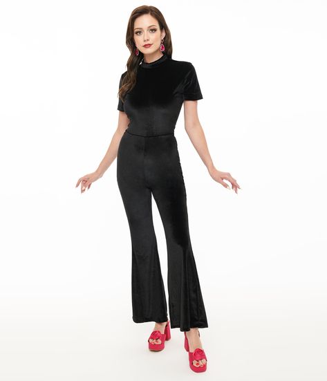 Crafted from luxurious black velvet, this stunning jumpsuit features a stylish mock neck and playful short sleeves that perfectly complement its retro-inspired bell bottoms. Zip up at the back for an effortlessly polished look that hugs your curves in all the right places..Available in sizes XS-XL while supplies last. | Miracle Eye Black Velvet Bell Bottom Jagger Jumpsuit | Size Xlarge Miracle Eye, Bell Bottom, Eye Black, Polished Look, Retro Inspired, Bell Bottoms, Black Velvet, Unique Vintage, Mock Neck