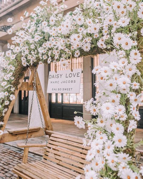 | DAISY • Marc Jacobs Daisy swing installation at @coventgardenldn . • @earlyhoursltd installation • A daisy themed transformation of the… Daisy Wedding Theme, Daisy Marc Jacobs, Daisy Wedding, Wedding Arbour, Marc Jacobs Daisy, Wedding 2025, Daisy Chain, Baby Party, Wedding Arch