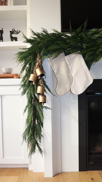 Chimney Garland Christmas, Christmas Garland On Cabinets, Fireplace With Garland, Christmas Mantle Stocking Decor, Bells On Mantle Christmas, Christmas Mantle Bells, Bells On Garland, Vintage Traditional Christmas Decor, Christmas Decor Mantle Ideas