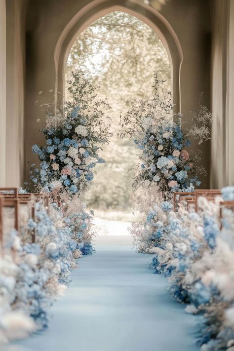 Elegant floral aisle adorned with blue and white flowers. Unleash your inner florist with wild and whimsical floral wedding ideas that will make your special day bloom like never before. Garden Wedding Blue Theme, Wedding Decorations Light Blue, Wedding Inspiration Blue And White, Wedding Ideas August, Light Blue Flowers Wedding, Black And White Wedding With Blue Accent, Bluebell Wedding Theme, Royal Inspired Wedding, Ice Blue Wedding Theme Winter Wonderland