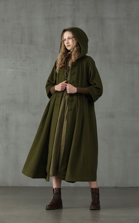 Embrace your sophisticated side with Linennaive Playing with proportions and details, we presents a new take on the classic 100% wool coat for our winter collection.  It is given an unique look with its oversized hood and napping 100% wool in moss green.  With deep side pockets and handmade pintucks all over the coat, it is cut for a mid-length and creates a striking voluminous silhouette.  We are sure this coat will make colder weather your favourite forecast.  Ensure that your outerwear is the Red Apron, Hooded Wool Coat, Cashmere Cape, Cozy Coats, Green Retro, Linen Fashion, Langer Mantel, Hooded Cloak, Coat Winter