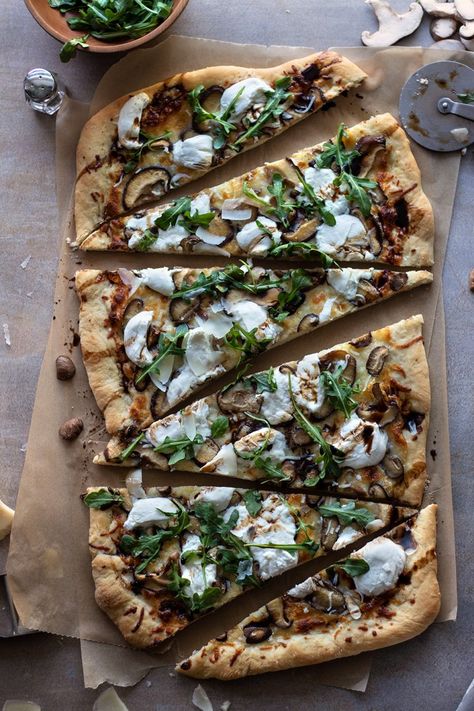 A little truffle oil, glaze and fancy greens is enough to upscale your next pizza! Truffle and Mushroom White Pizza with Arugula is a three-cheese pizza, made in 30 minutes and is sure to impress. Mushroom Pesto Pizza, Mushroom Goat Cheese Pizza, Mushroom Arugula Pizza, Truffle Pizza Mushroom, Truffle Oil Pizza Recipes, White Truffle Pizza, Fancy Pizza Toppings, Truffle Pizza Recipe, Truffle Olive Oil Recipes