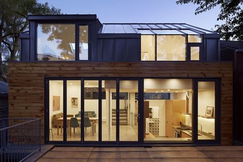 In order to maximize space, the architects utilized a split-level design that includes the living areas on the main level, two upstairs bedrooms, and a walk-out basement beneath the dining room. The wood siding was salvaged and restored from the previous building on-site, in order to bring warmth to the gray, seamed metal and reference the neighborhood's past. Polished Cement Floors, Laneway House, Garden Suite, Concrete Roof, Condo Living, Wood Siding, Interior Architect, Roof Design, Green Roof