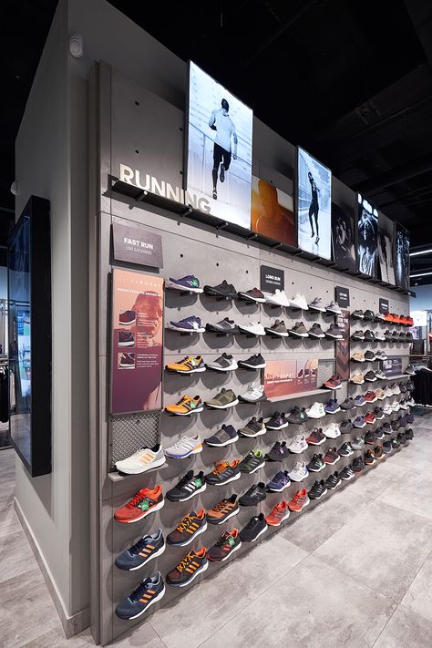 The interior of the Adidas store is contemporary and stylish. To suit the brief, Cemcrete’s CreteCote in Nickel Grey was further used for the display shelving. A magnificent backdrop for some of the brand’s quality product offerings! Adidas Store Interior, Running Store Design, Sport Store Design Shop Interiors, Adidas Store Design, Sport Shop Design, Sports Shop Interior Design, Sports Store Design, Shoes Shop Design Ideas, Sport Store Design