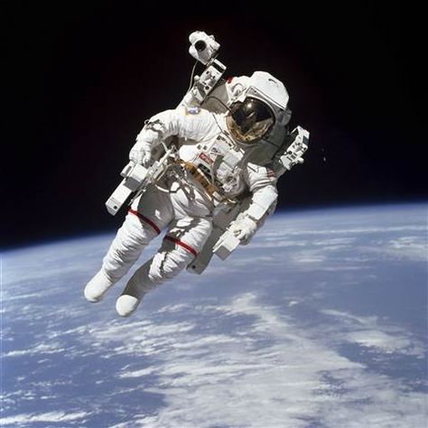 Image: This Feb. 7, 1984 photo made available by NASA shows astronaut Bruce McCandless II, participating in a spacewalk a few meters away from the cabin of the Earth-orbiting space shuttle Challenger, using a nitrogen-propelled Manned Maneuvering Unit. Background Stars, Space Shuttle Challenger, Nasa Missions, Sky Stars, Nasa Astronauts, Space Photos, Astronauts In Space, Apollo 11, Space Pictures