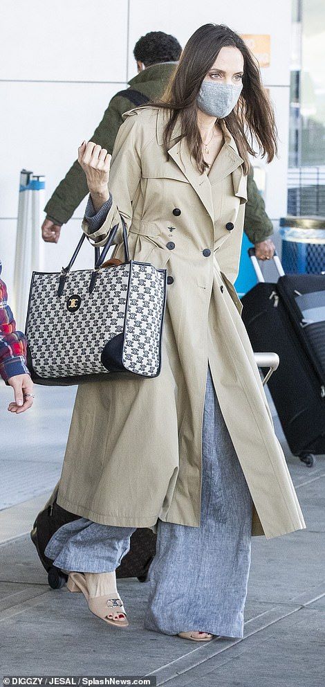 Perturbed: In late May, the court ruled that Brad and Angelina will have shared custody of... Fall Trench Coat, Outfit Trench, Fall Trench, Simple Midi Dress, Women Street Style, Celine Tote Bag, Angelina Jolie Style, Brad And Angelina, Celine Tote