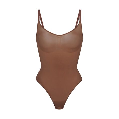 Sculpt your waist, tone your tummy, and define your bust in this comfortable scoop neck shapewear thong bodysuit. Features mid-level compression along the tummy and waist, adjustable convertible straps with hooks that can be worn at the shoulder or cross back, and a cotton gusset with snap closure. Fits true to size. | SKIMS Bodysuit | Medium Neutral | 3X | Everyday Sculpt Shapewear Thong, Shapewear, Snap Closure, Convertible, Scoop Neck, Lounge Wear