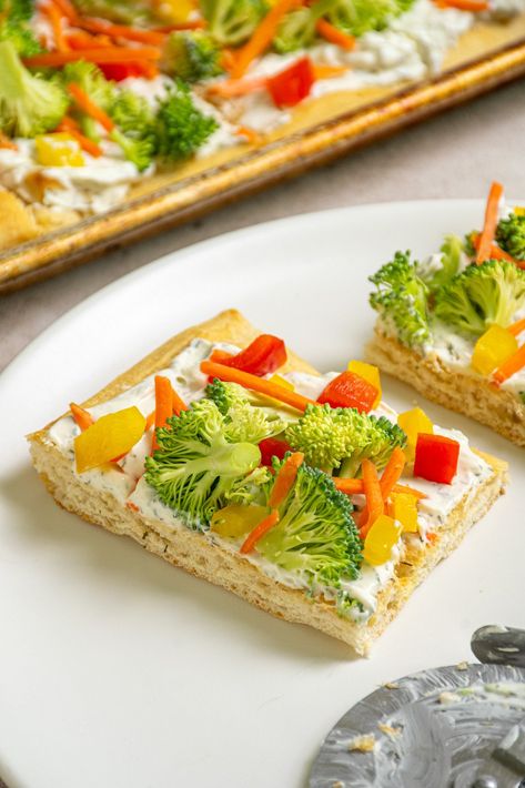 This Crescent Roll Veggie Pizza recipe has a golden, flaky crust topped with a creamy herbed spread, and piled high with fresh, colorful veggies. Crescent Veggie Pizza Appetizers, Veggie Squares Crescent Rolls, Veggie Cream Cheese Pizza, Fresh Veggie Pizza, Crescent Roll Veggie Pizza Cream Cheeses, Vegetable Pizza Crescent Roll, Veggie Pizza With Cream Cheese, Veggie Pizza Recipes, Vegi Pizza