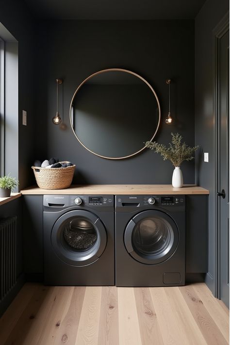 Minimalist laundry room with dark walls and light wood accents Moody Utility Room, Sage Green And Black Laundry Room, Utility Room Paint Color Ideas, Black Laundry Room Walls, Black Utility Room, Laundry Room With Black Washer And Dryer, Entryway Laundry Room Ideas, Cozy Laundry Room Ideas, Laundry And Storage Room Ideas