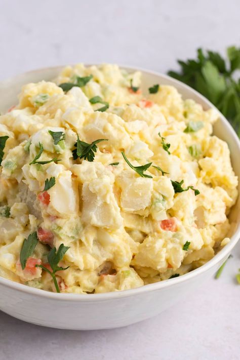 This Amish potato salad will be the hit of any potluck! Learn how to make the easy recipe, and get tips for the creamiest, most delicious potato salad. Amish Potato Salad, Amish Potato Salads, Deviled Egg Potato Salad, Potato Salad Recipes, Homemade Potato Salads, Southern Potato Salad, Potato Salad Dressing, Potato Salad With Egg, German Potato Salad