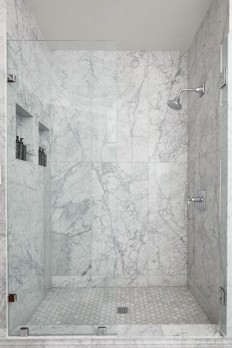 Marble is an exquisite stone that embodies the beauty of nature. With its beautiful veining and patterns, it is sure to capture attention in any application. Large Format Bianco Carrara tile creates a sophisticated look in this shower of a historic home. Tap the photo to learn more. #whitemarble #marbleshower #whitemarbletile Marble Tile Shower, Carrara Bathroom, Carrera Marble Bathroom, Marble Accent Wall, White Marble Shower, Marble Shower Walls, Carrara Marble Bathroom, Marble Shower Tile, Tile Bedroom