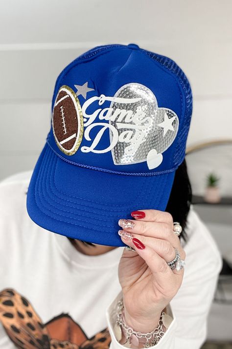 Get ready for game day with this vibrant and fun Game Day trucker hat! Perfect for football fans, this hat adds a playful touch to any outfit while showing off your team spirit. Whether you're tailgating or watching the game from home, this hat is a must-have accessory. Game day hat, football fan accessories, women’s trucker hat, stylish game day hat, team spirit accessories, game day fashion Football Game Accessories, Football Mom Trucker Hats, Football Patch Hat, Football Trucker Hat With Patches, Patch Hats Baseball Caps, Ball Cap Design, Mom Trucker Hats, Football Trucker Hat Ideas, Game Day Trucker Hat